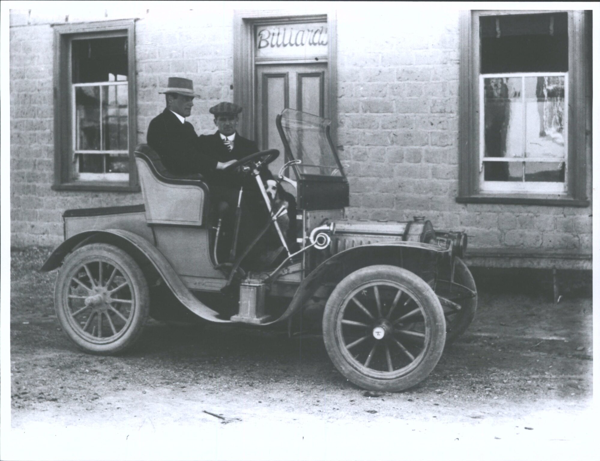 Two Men and a Dog in a Car