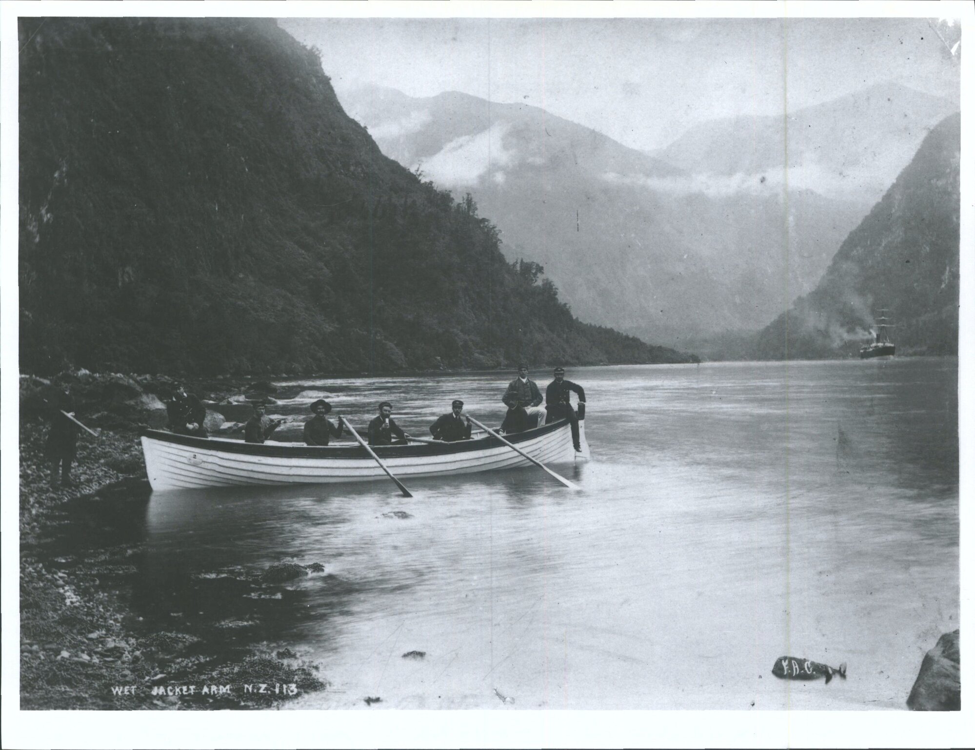 Men posing in rowboat, Wet Jacket Arm, Dusky Sound