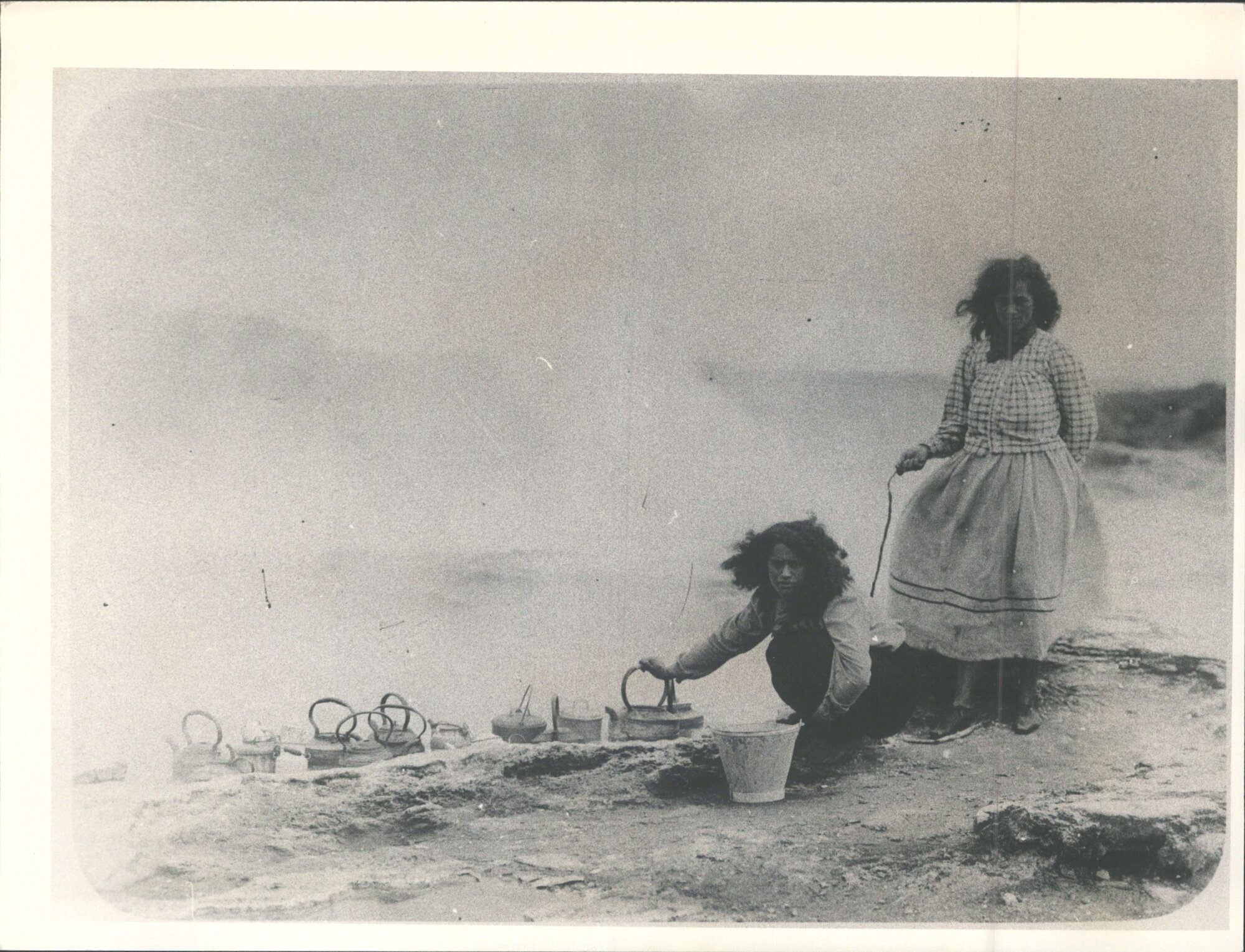 Maori women heating water in hot pool
