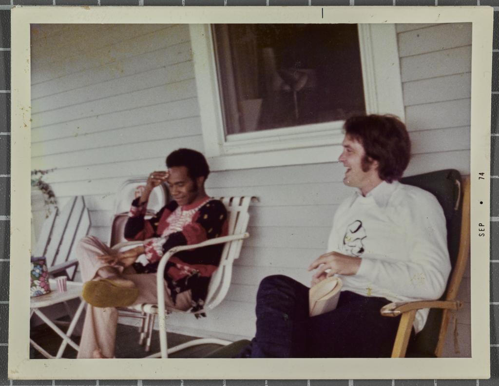 Robert Lord and another man sitting on the deck of a house