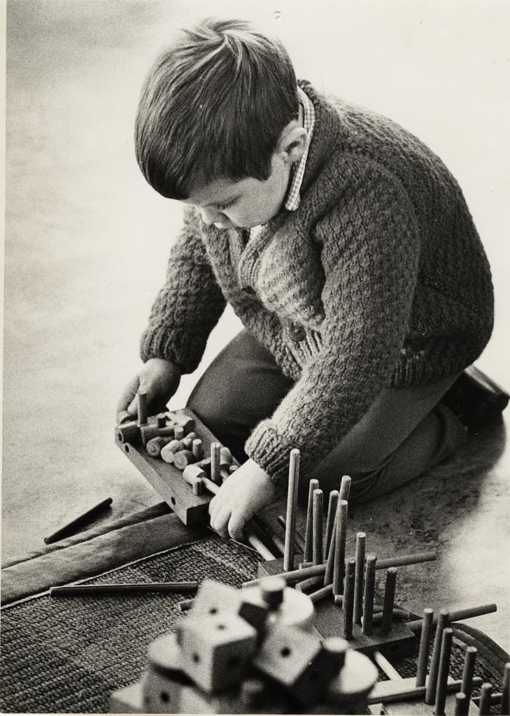 Child playing with wooden pegs