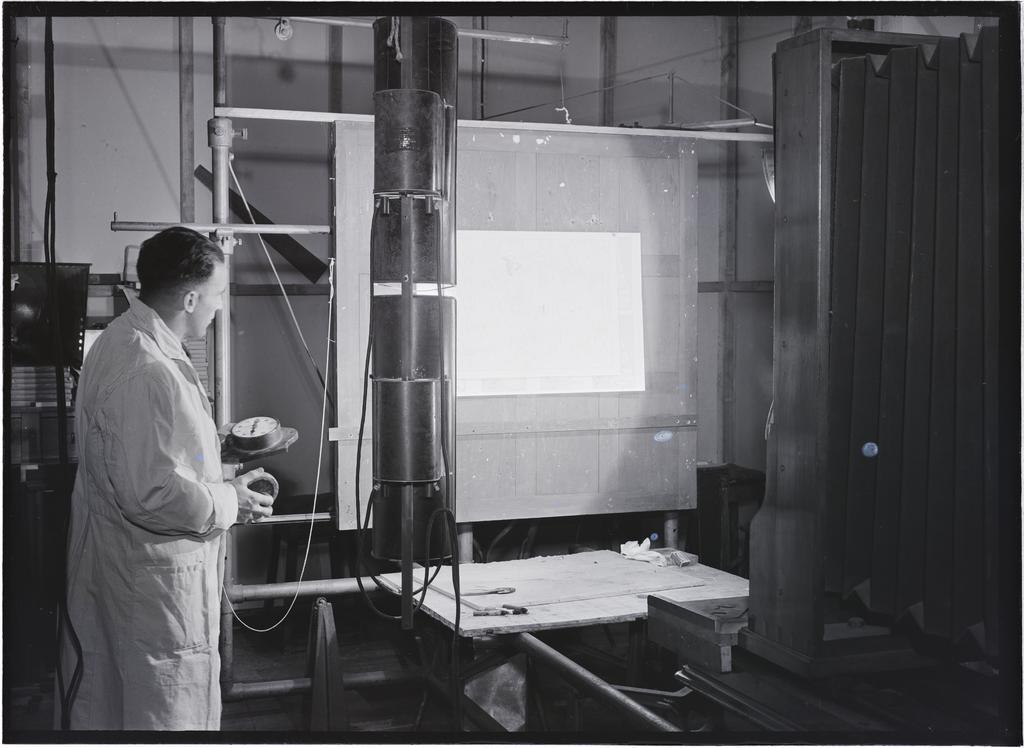 Man with photographic equipment, Coulls Somerville Wilkie, Crawford Street, Dunedin