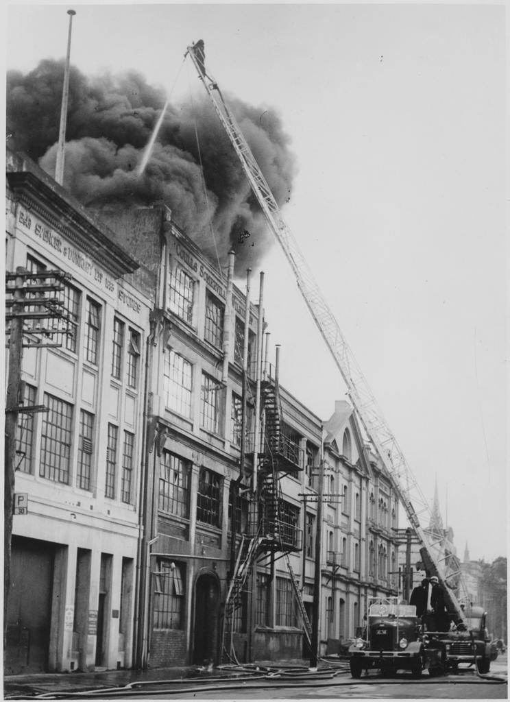 Fire scene at Coulls Somerville Wilkie Limited, Vogel Street, with engine and ladder at scene