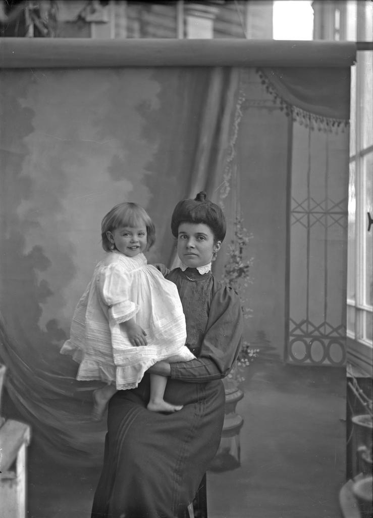 Fred McGeorge in dress, held by Ethel McGeorge