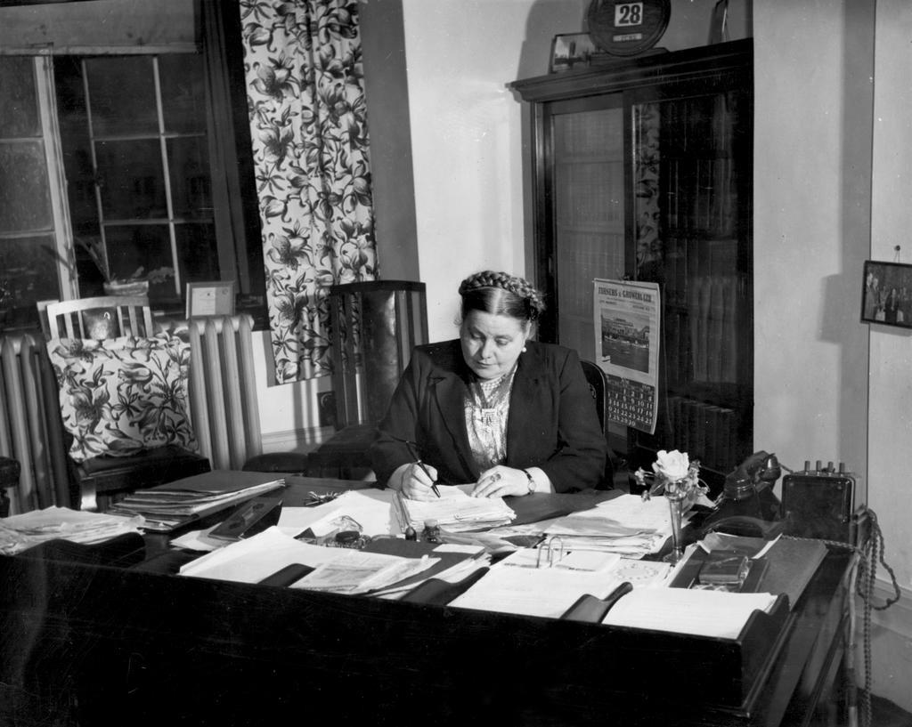 Mabel Howard writing at her desk