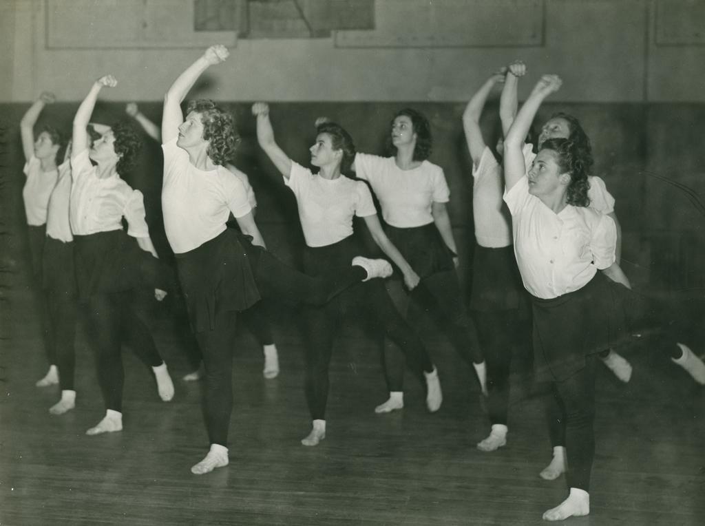 Ten dancers facing stage left
