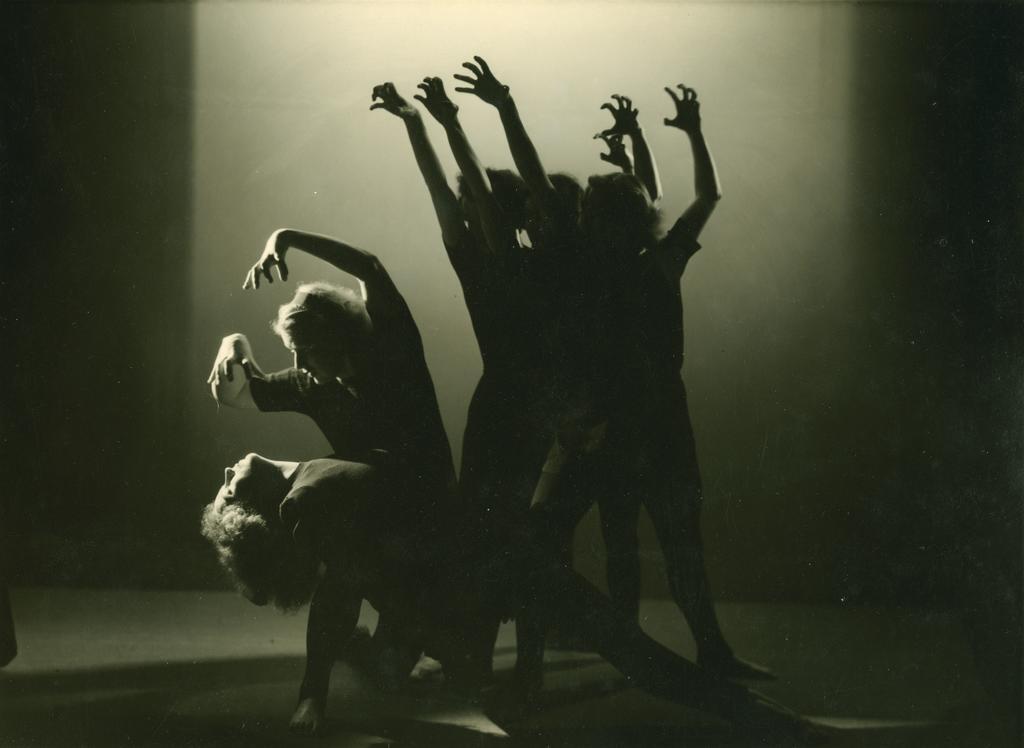 Five dancers, arms raised like claws