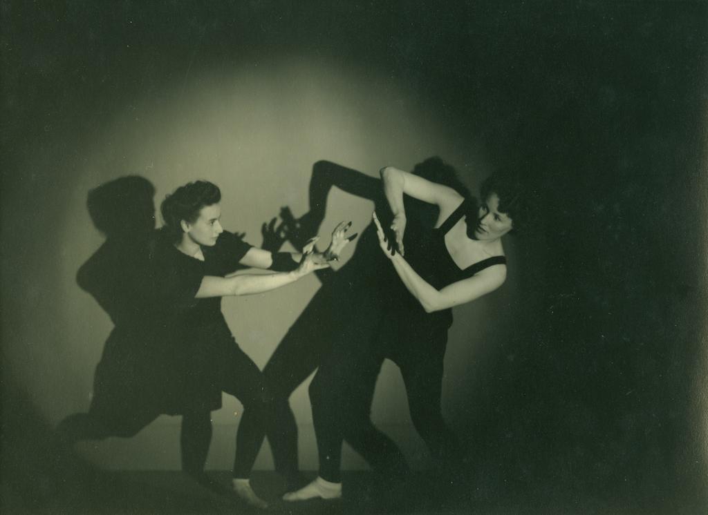 Two dancers, facing each other