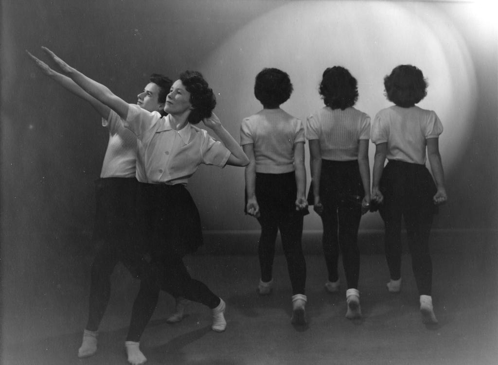 A group of two facing left and three facing away from camera