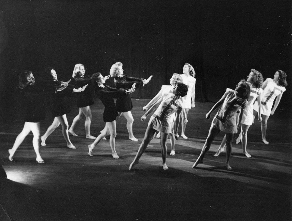 11 dancers, five dressed in black, six in white