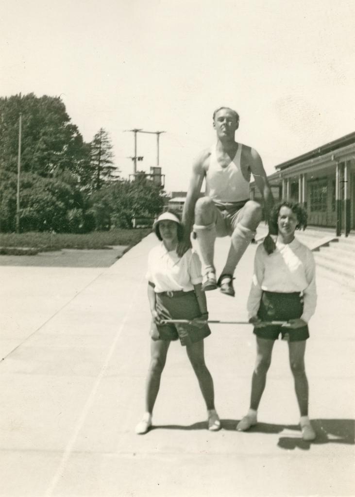 Philip Smithells and two women in outdoor gymnastic demonstration