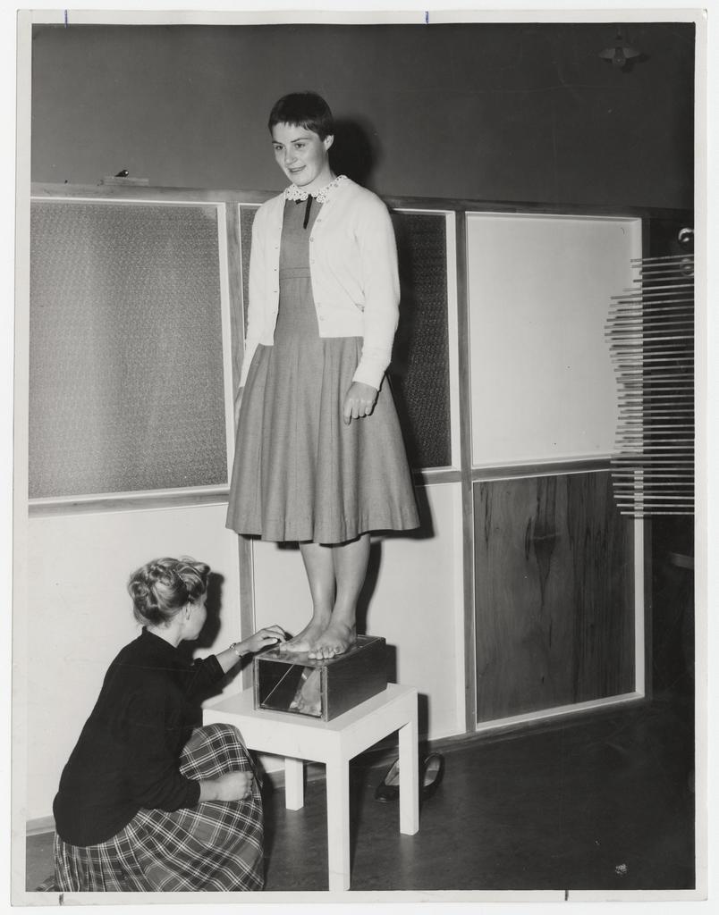 A student, Alison Bell, the well-known swimmer, has her feet examined by senior students in the Clinic for Individual Physical Education