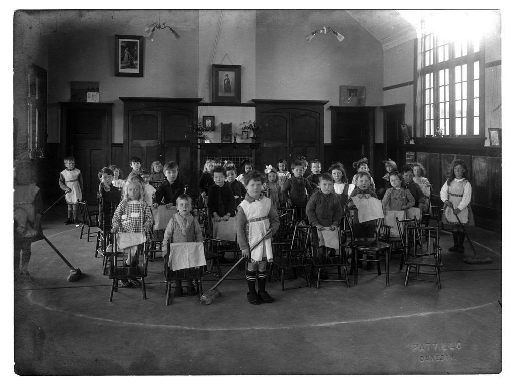 Children with brooms and cloths