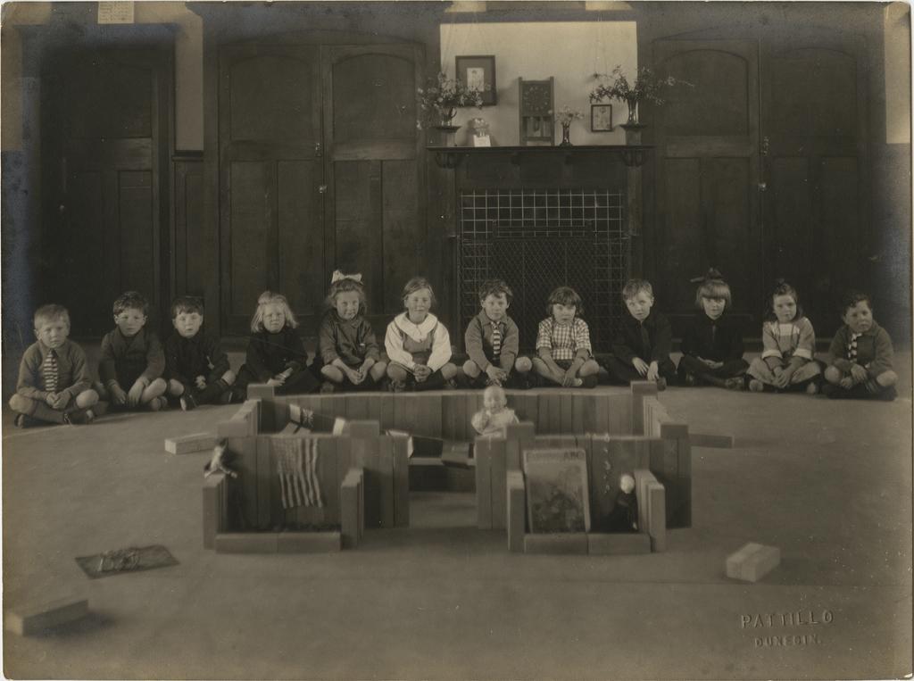 Children sitting indoors on the floor