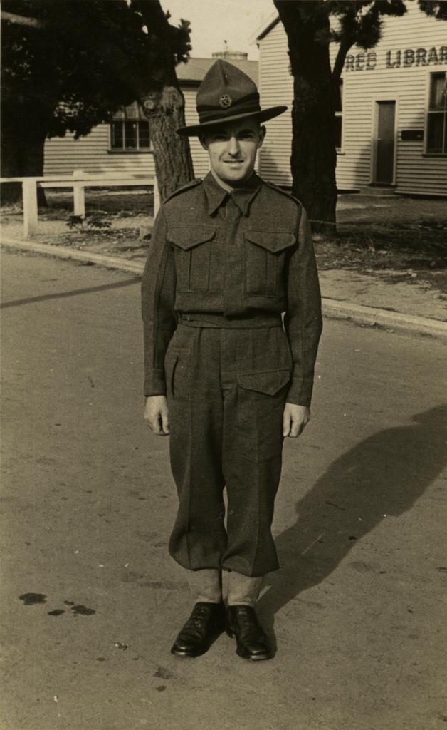 Soldier standing in front of free library