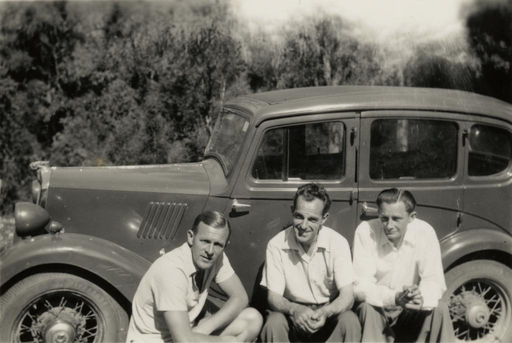 Three men with car