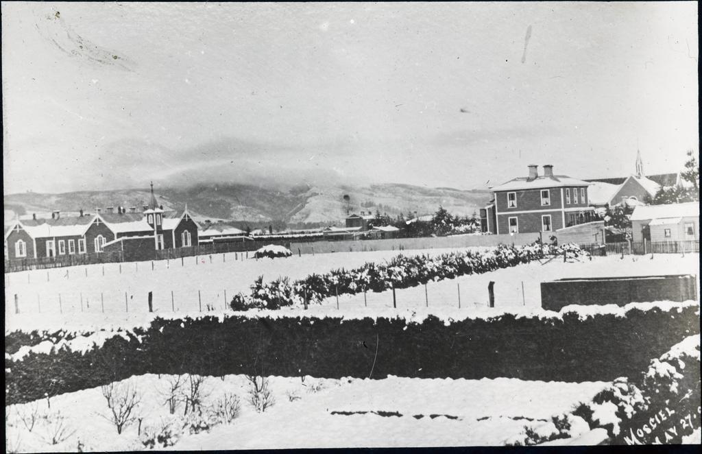 'School, church and manse under snow 27 May [1895]', Mosgiel