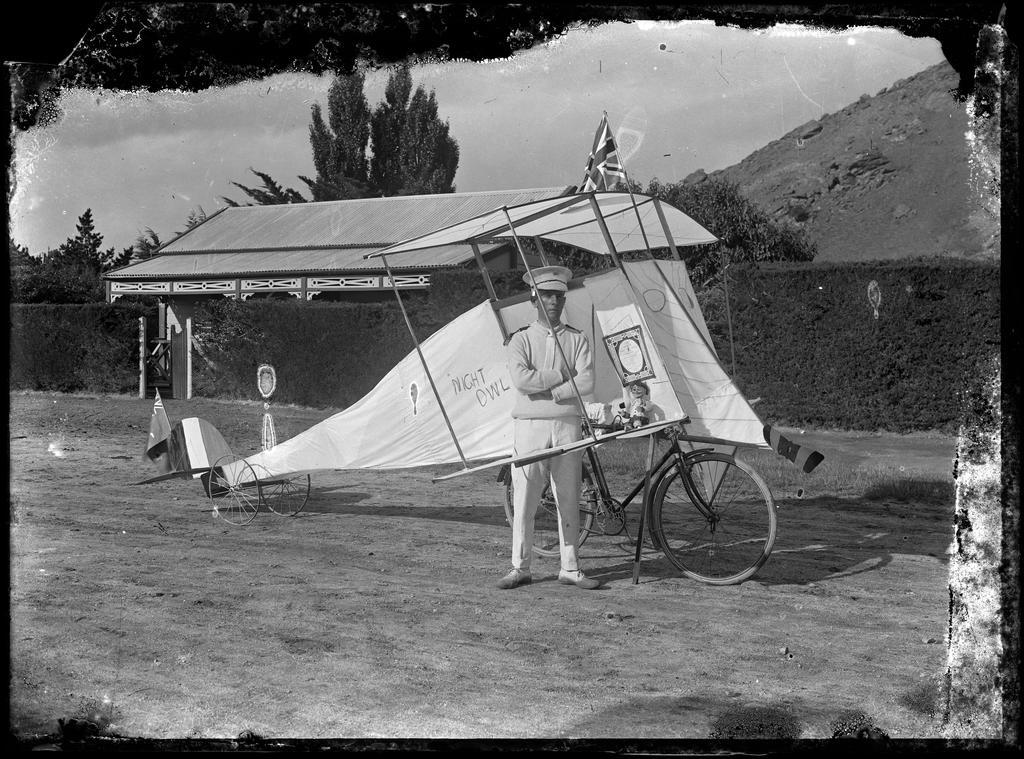 Man standing beside 'Night Owl' bicycle-powered plane