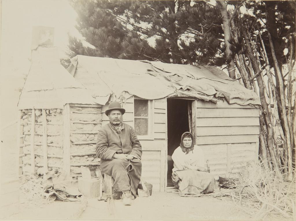 Jack Mamaru and unidentified wahine Māori in front of dwelling