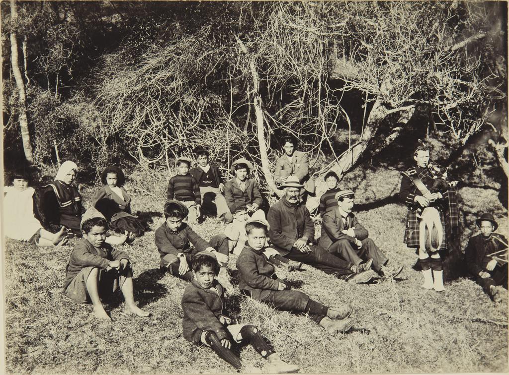 Group of adults and children on a grassy bank