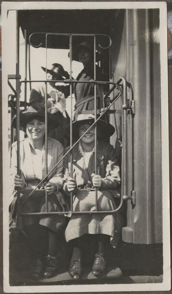 Four Te Wai Pounamu College girls behind metal gate