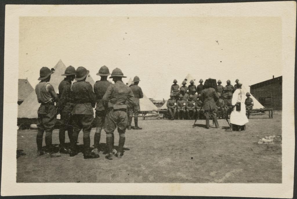 Soldiers at camp, a group is having a photograph taken