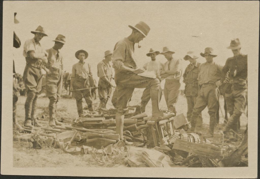 'Checking a few of the rifles and machine guns captured from Turks...'