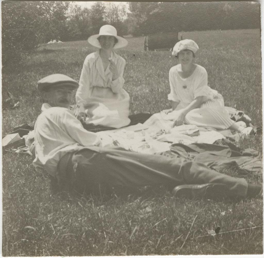 Picnic scene showing a man and two women