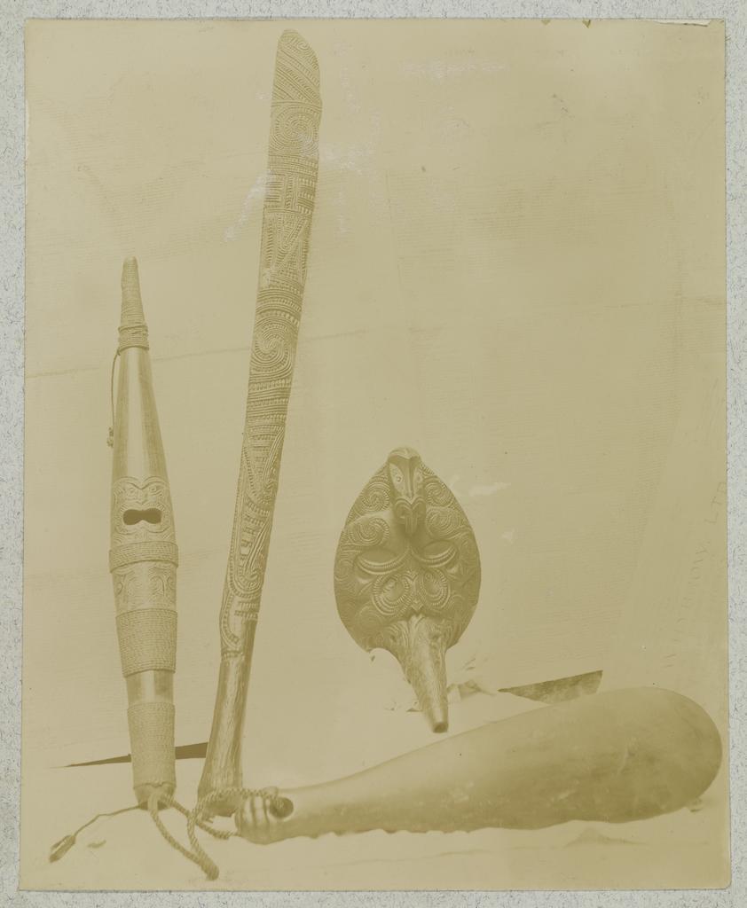 Carved clubs, flute and feeding tube