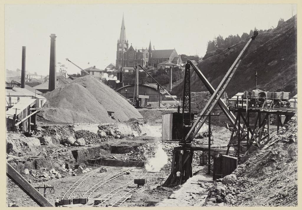 View of cranes and large mountains of loose soil