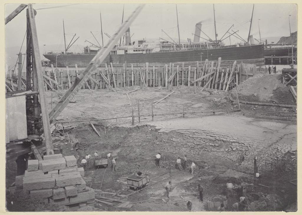 Elevated view of men excavating seabed soil