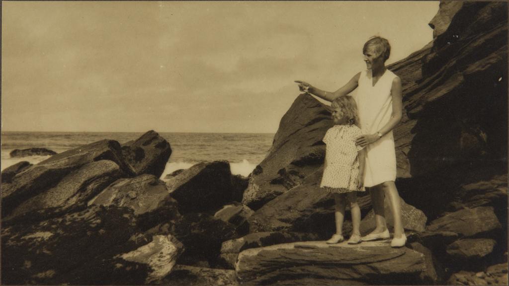 Lorna Chance with her sister Gwenda on a rock at the beach