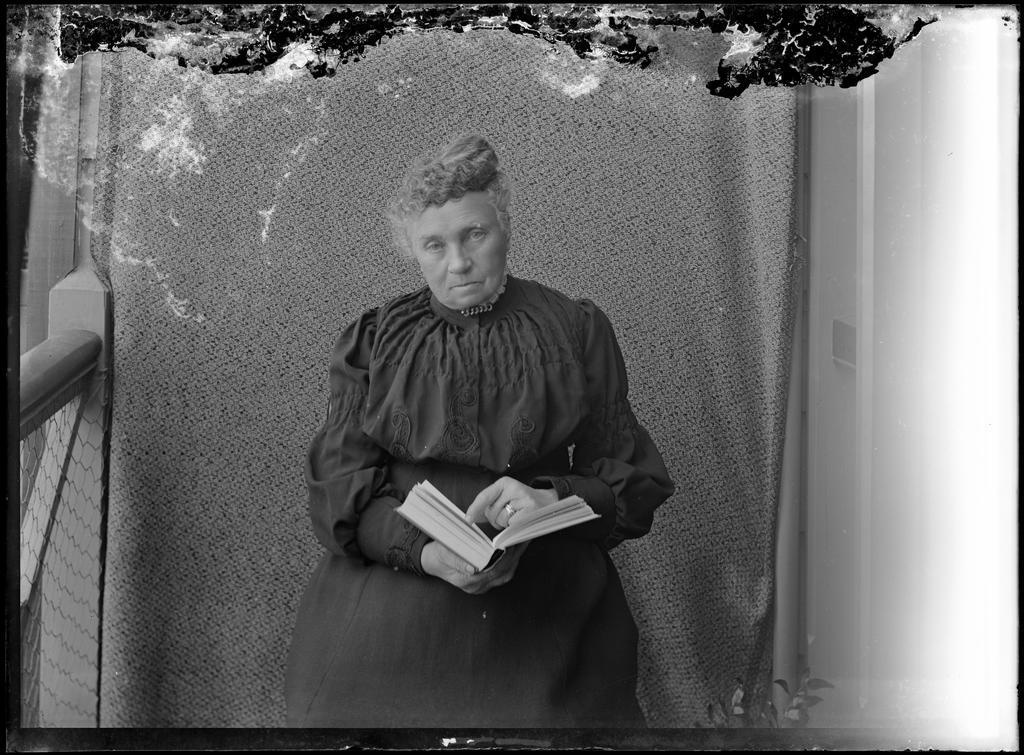 Elderly woman holding a book