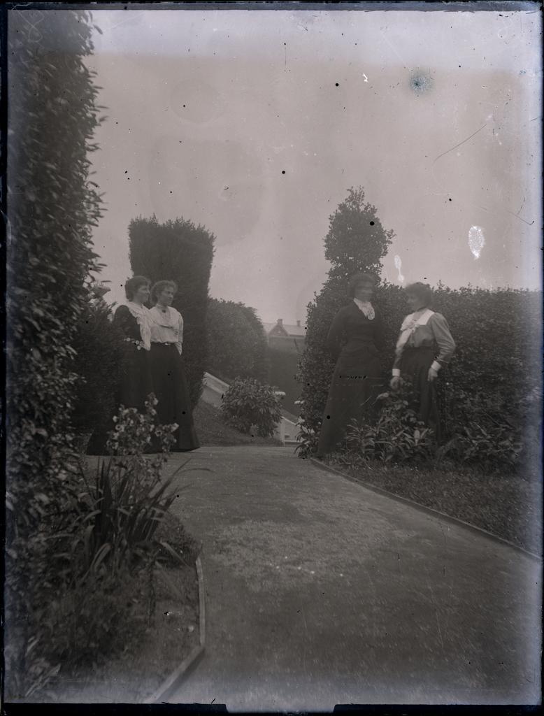 Four women in a formal garden