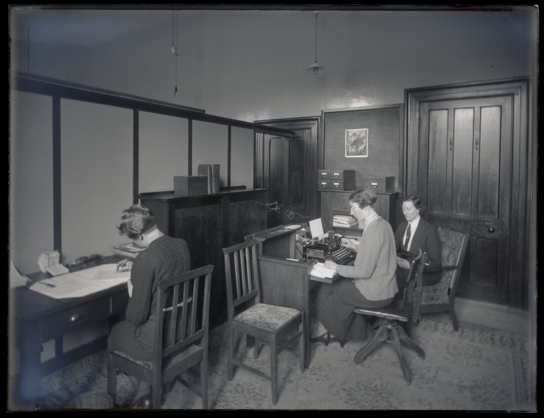 Office including students, desks, and typewriter, School of Home Science
