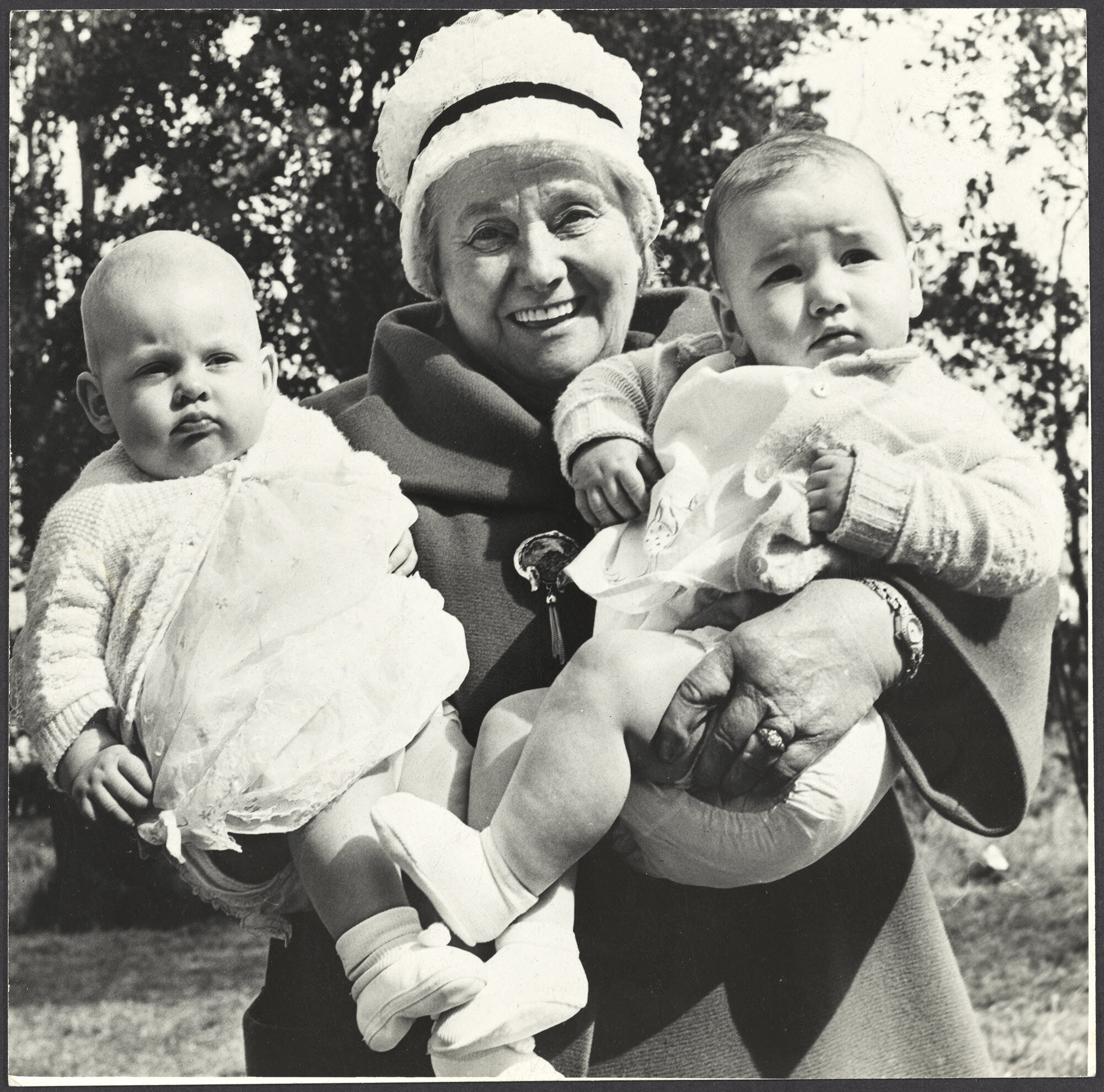 Mabel Howard holding two babies at a Labour Day picnic