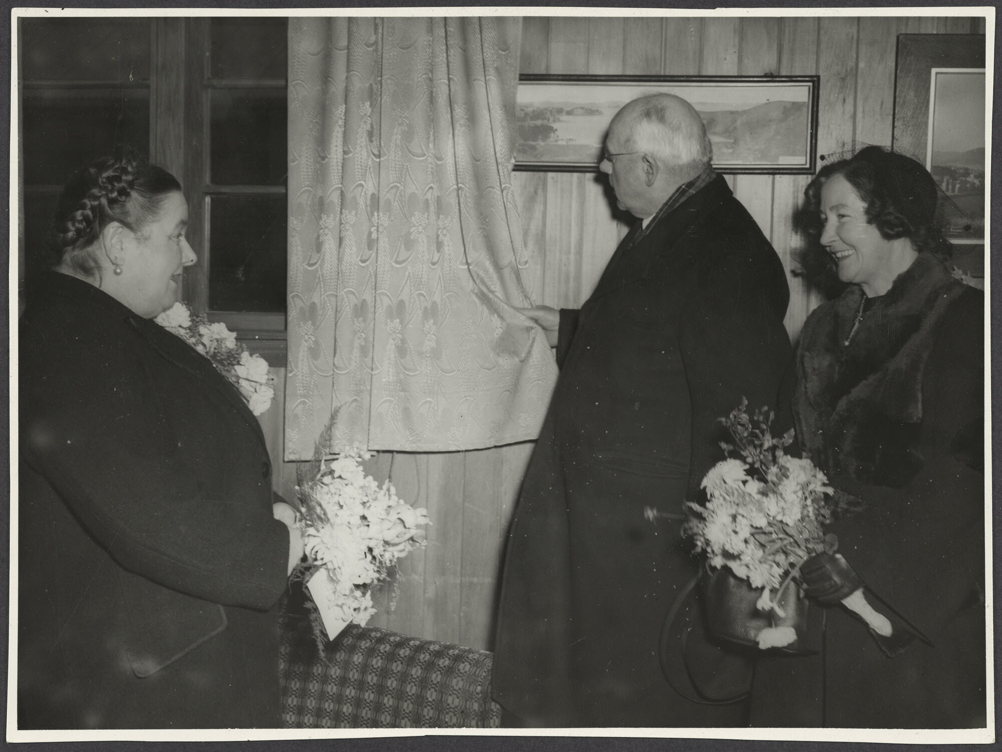 Peter Fraser inspecting curtains at Howardville with Mabel Howard and an unidentified woman