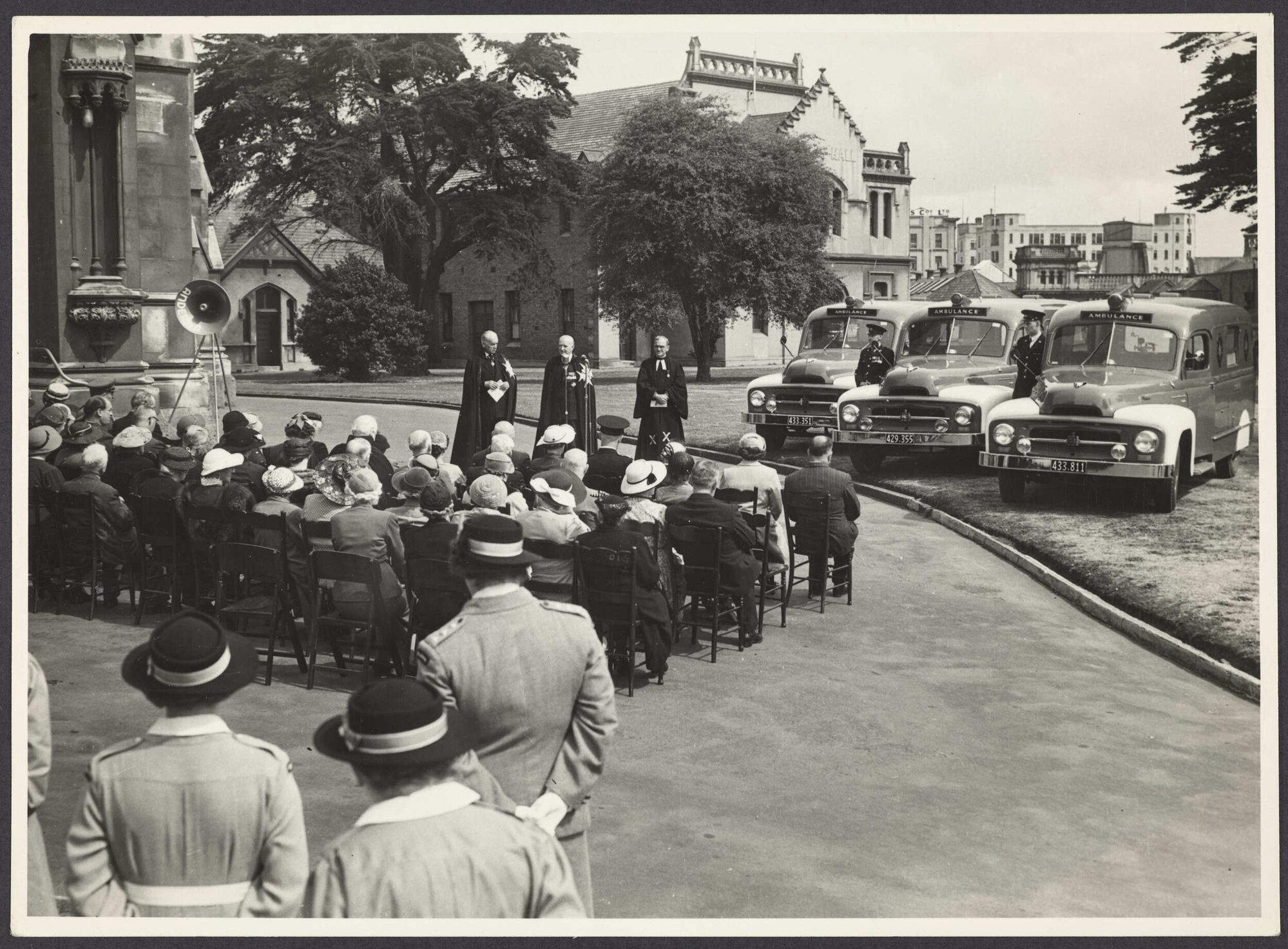 Ceremony outside First Church, Dunedin, with three ambulances