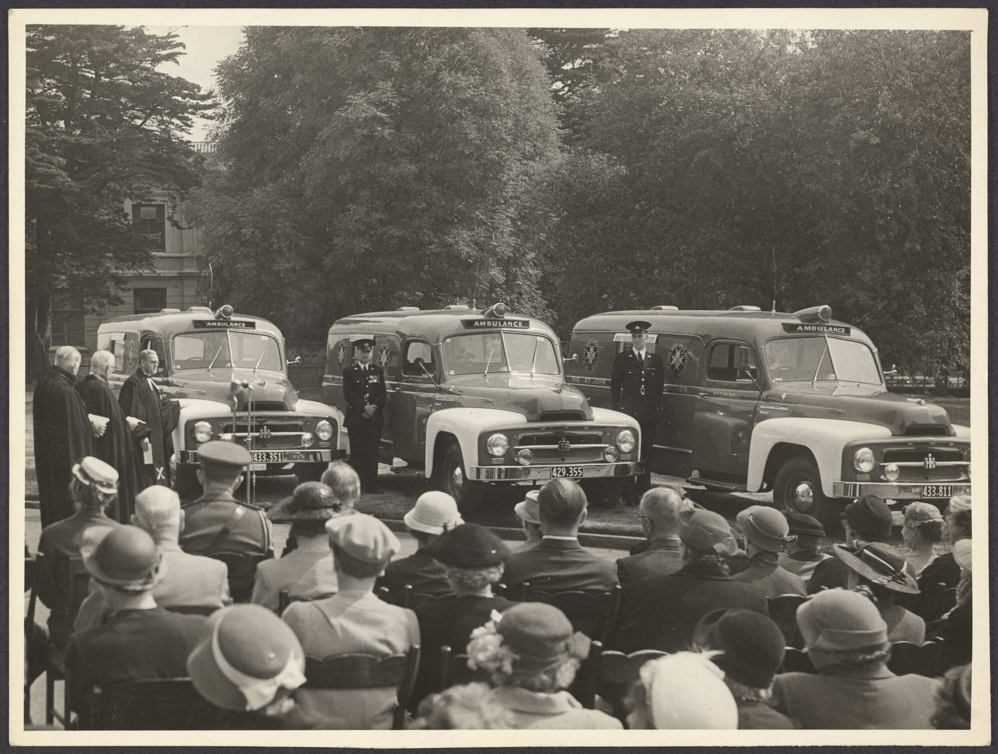 Ceremony outside First Church, Dunedin, with three ambulances