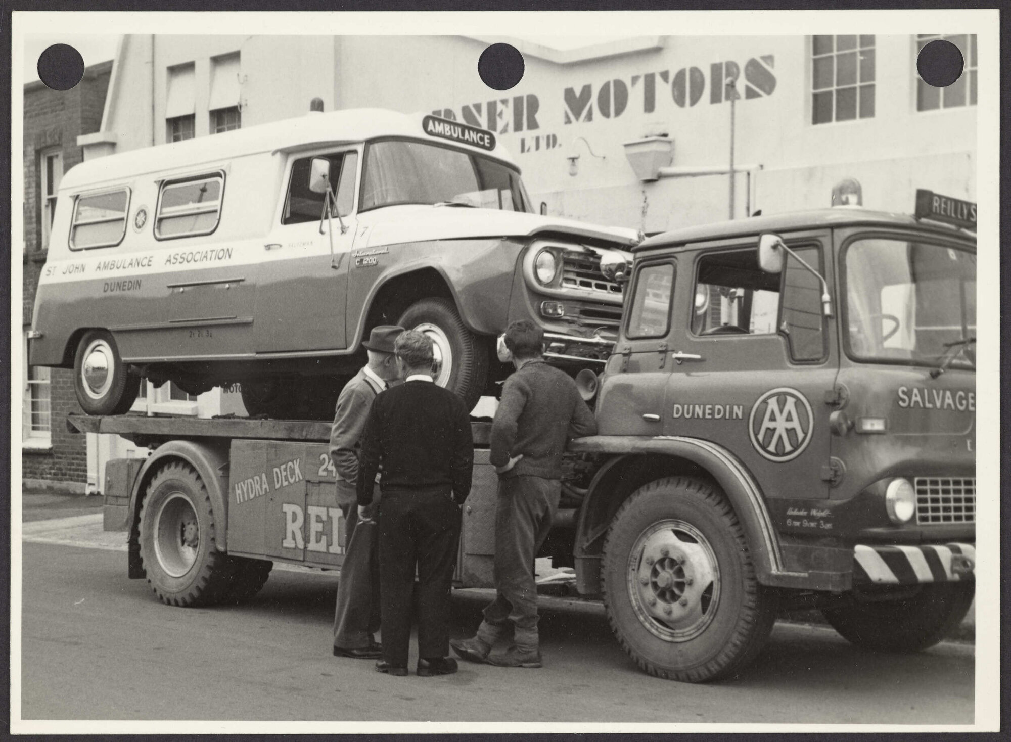 Ambulance on a Reilly's salvage truck outside Gardner Motors