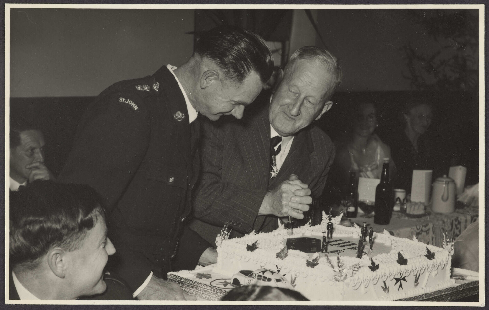 Mr Mulholland cutting a cake at a St John Ambulance Association event