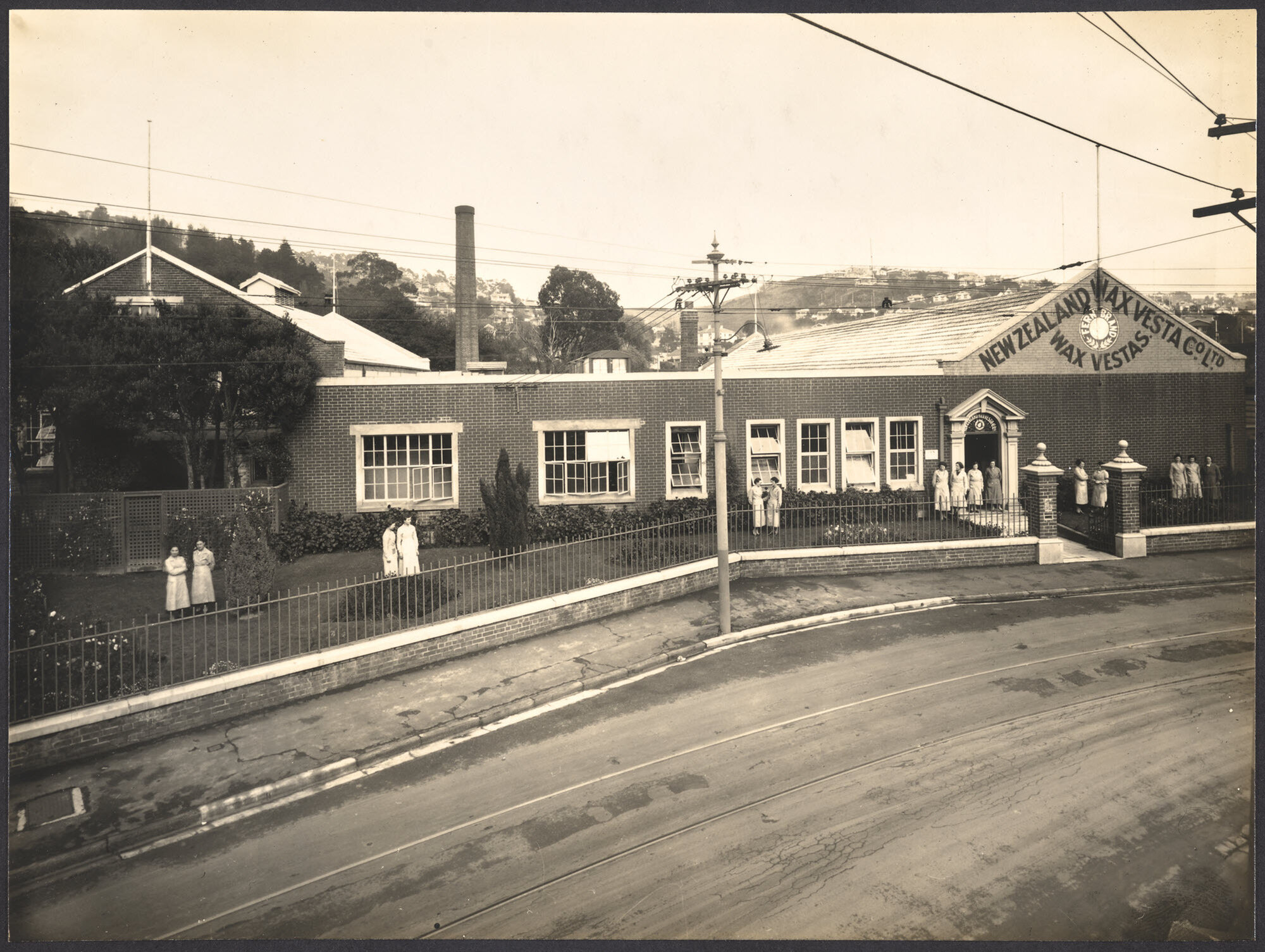 A quiet chat in factory grounds during afternoon tea recess