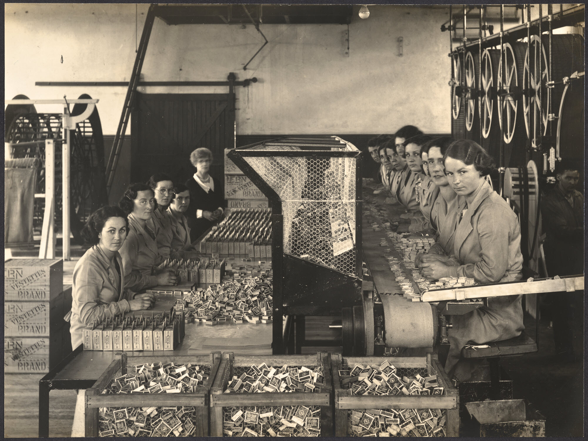 A close up of the 'Vestette' Packing and Wrapping Benches adjoining Match Machine