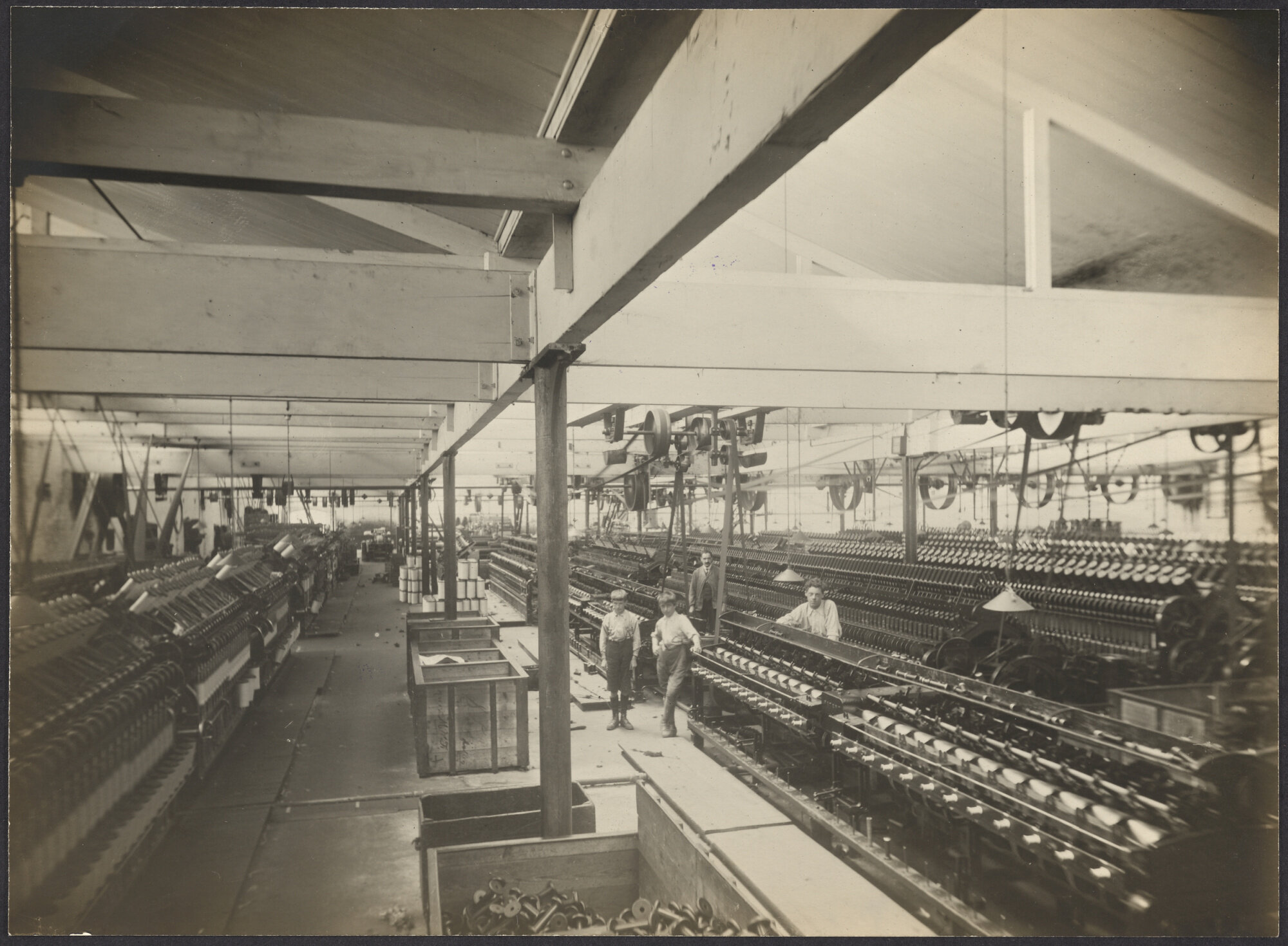 Interior view of large room with spinning machines or 'mules'