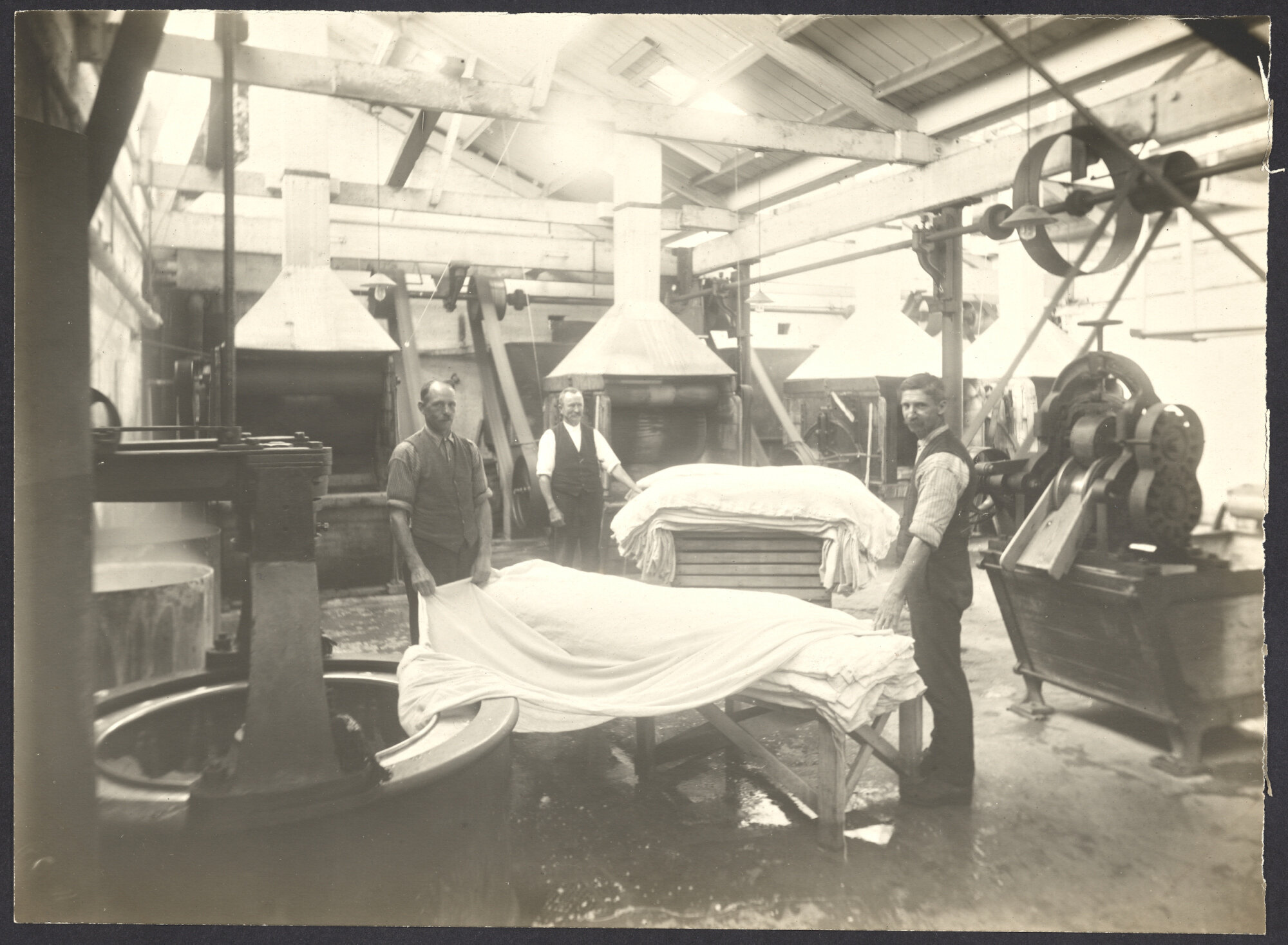 Male workers with cloth and machinery