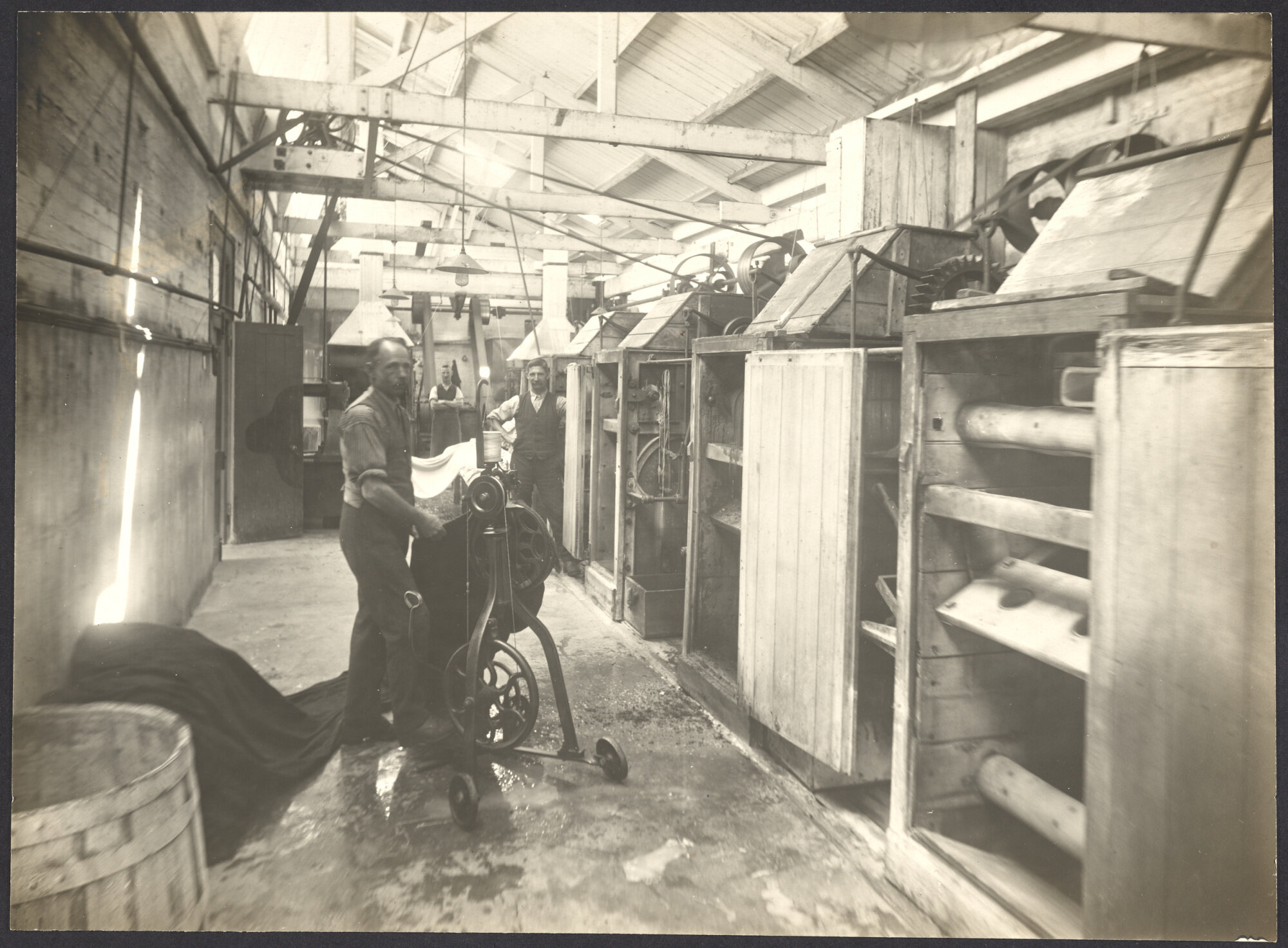 Male workers with cloth and machinery