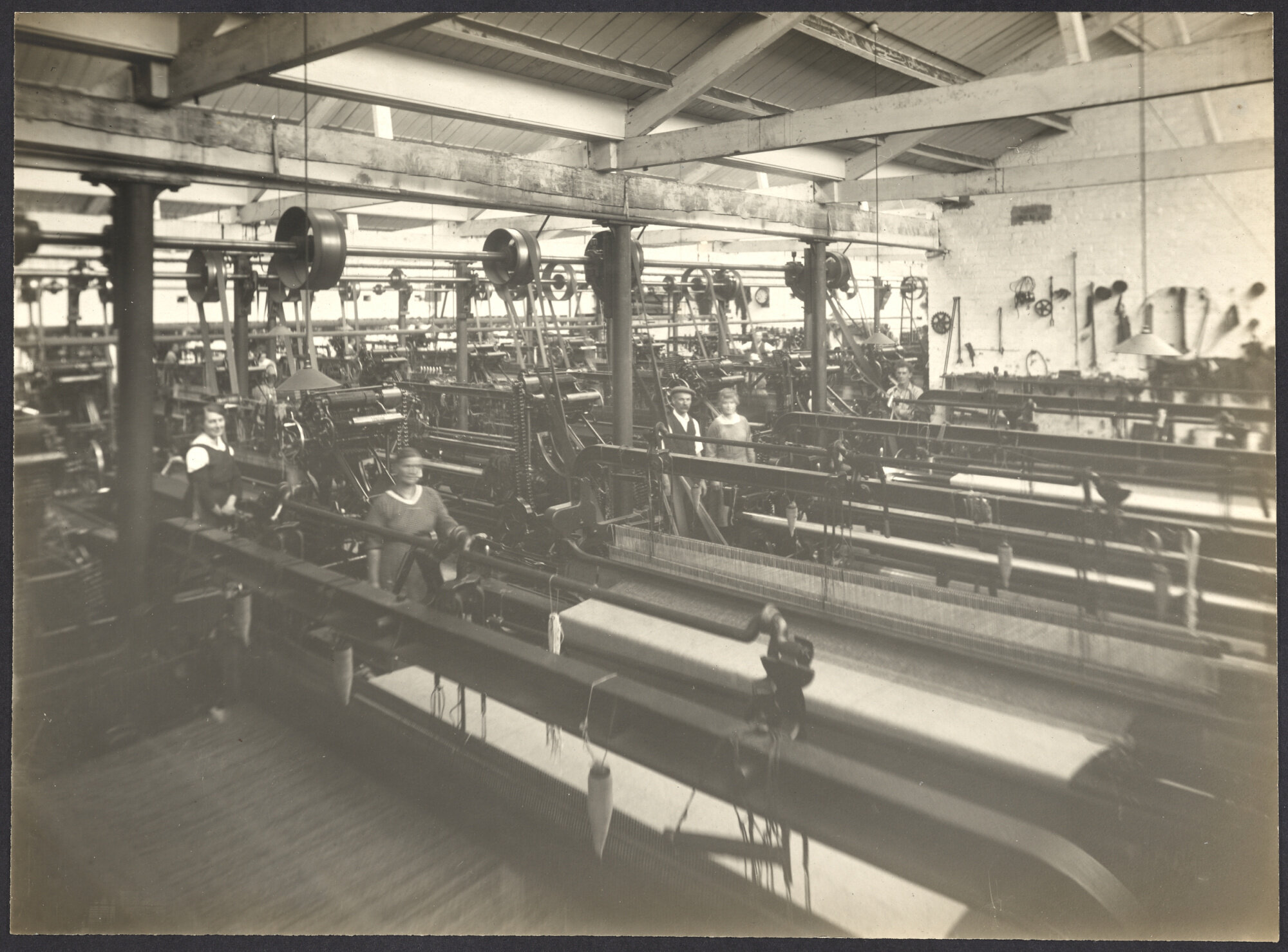 Interior with power weaving looms and workers