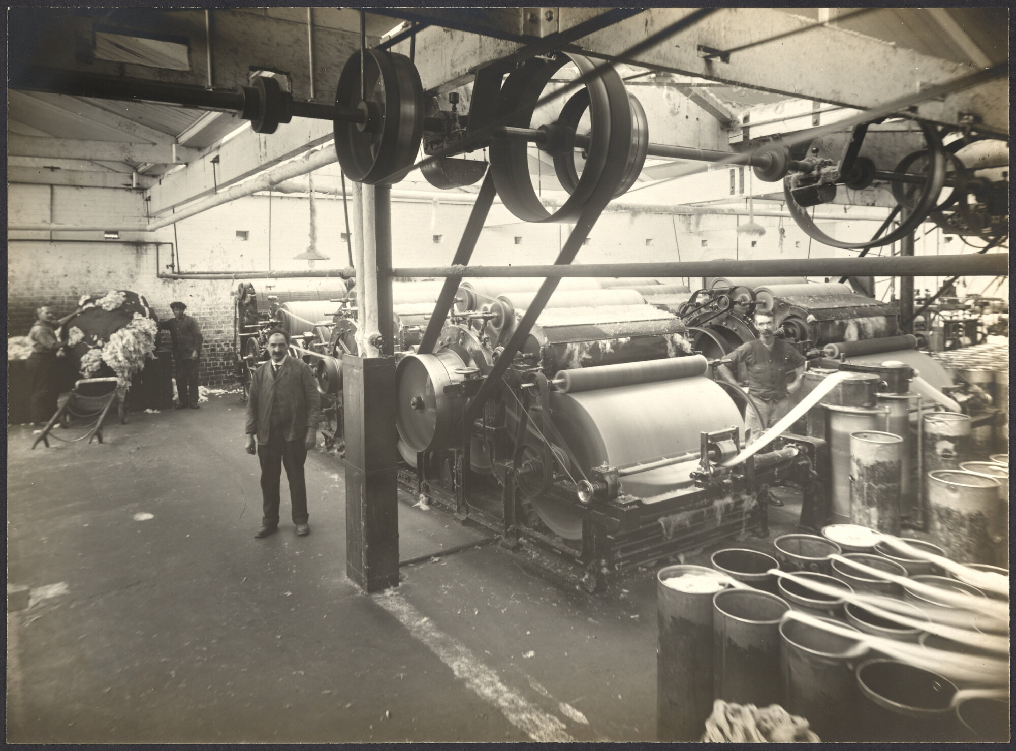 Workers with larger carding machines, making sliver or roving prior to spinning the wool