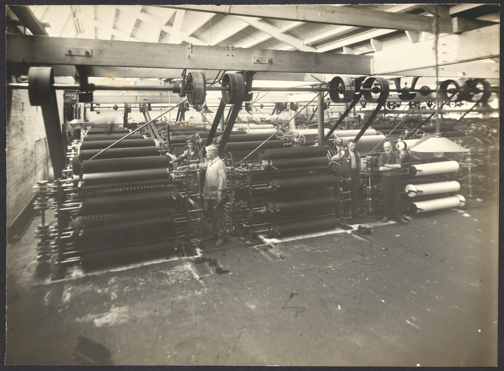 Workers with machines, probably part of spinning processes