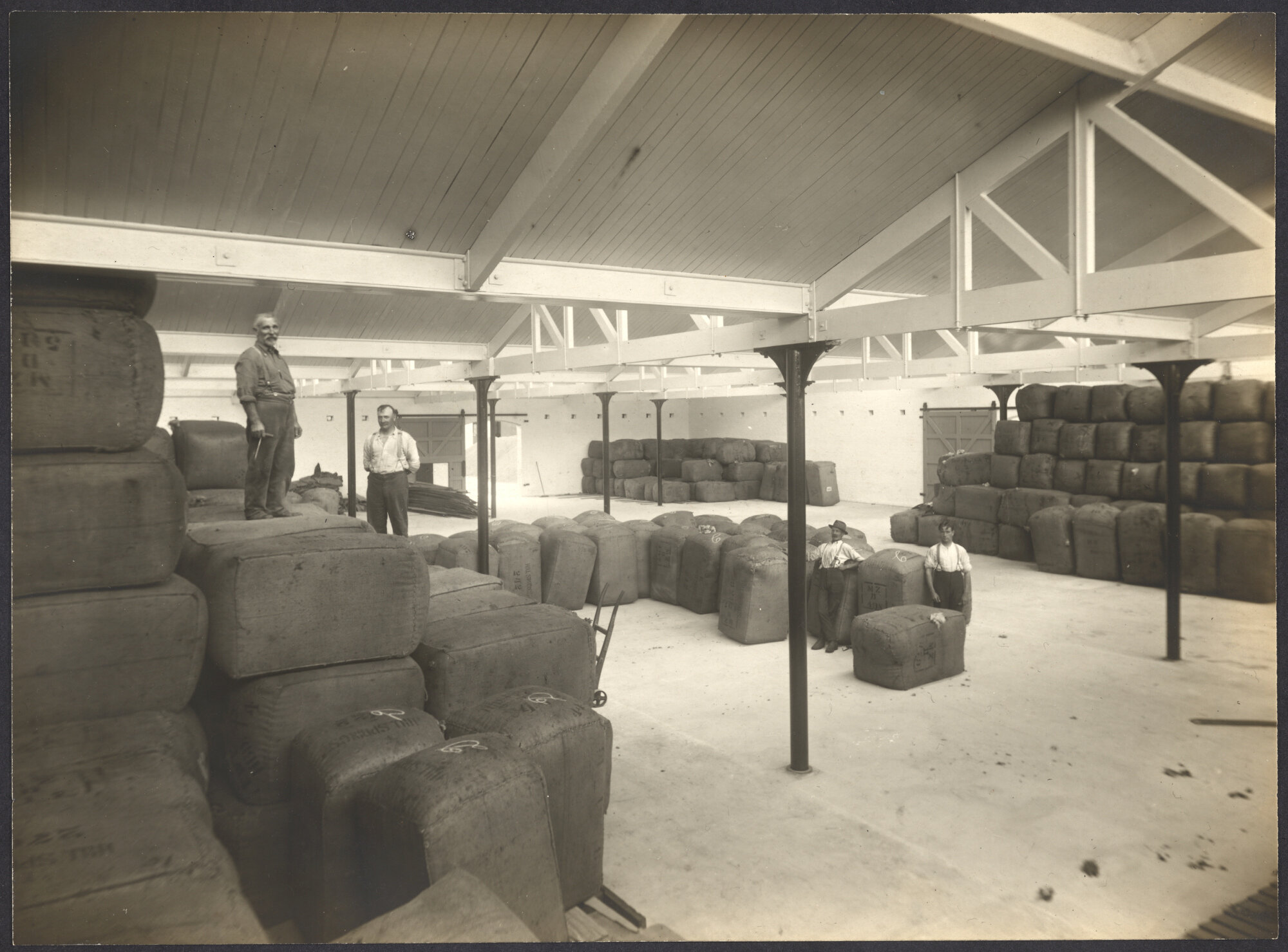 Bales of wool with workers
